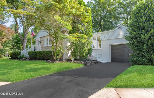 79 Lake Shore Dr, Red Bank, NJ 07701 - view of property hidden behind natural elements featuring a garage, asphalt driveway, a front lawn, and stucco siding