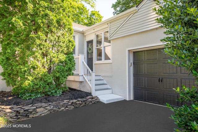 79 Lake Shore Dr, Red Bank, NJ 07701 - view of exterior entry with stucco siding and a garage
