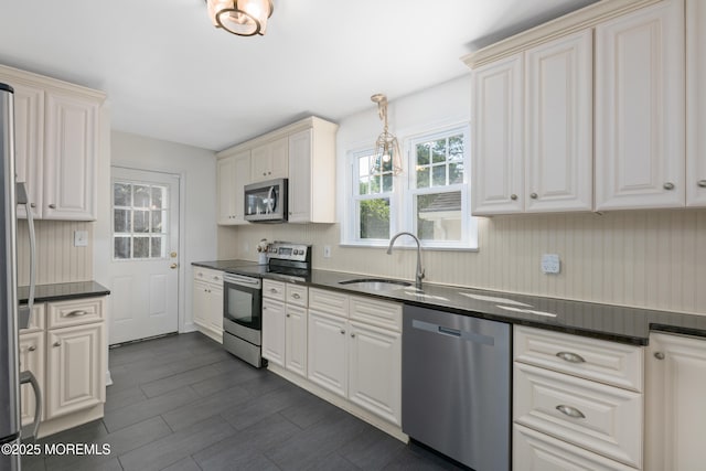 79 Lake Shore Dr, Red Bank, NJ 07701 - kitchen featuring appliances with stainless steel finishes, dark countertops, and white cabinets