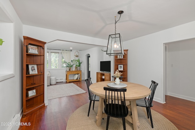79 Lake Shore Dr, Red Bank, NJ 07701 - dining room featuring arched walkways, dark wood-style floors, and baseboard heating