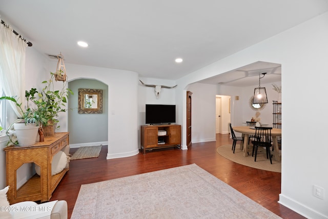 79 Lake Shore Dr, Red Bank, NJ 07701 - living area featuring arched walkways, dark wood-type flooring, and recessed lighting