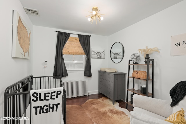 79 Lake Shore Dr, Red Bank, NJ 07701 - bedroom featuring radiator, wood finished floors, and a nursery area