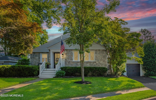 79 Lake Shore Dr, Red Bank, NJ 07701 - view of front of house with stone siding, a front lawn, asphalt driveway, and a garage