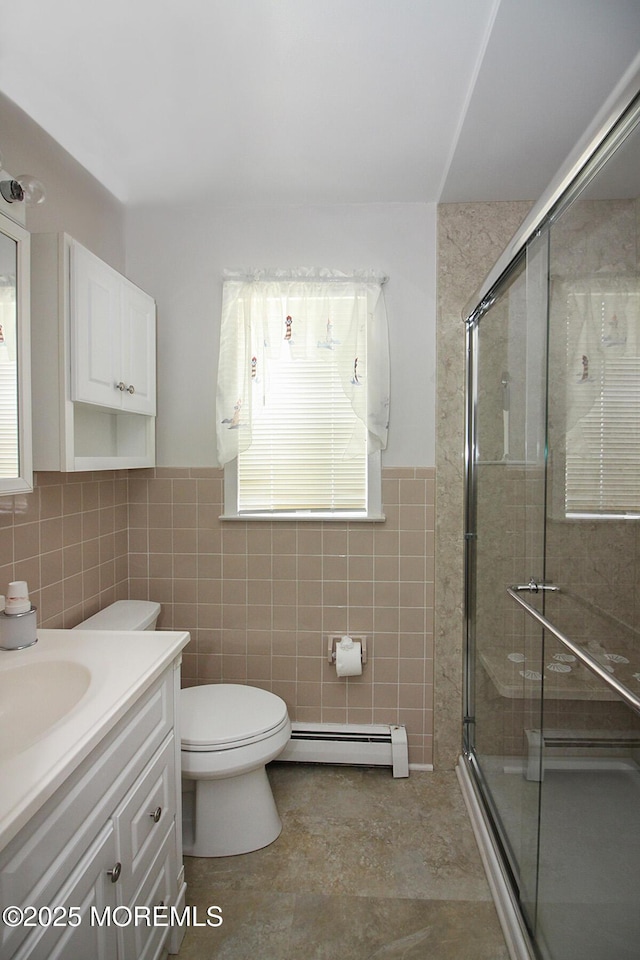 288 Barbados Dr N, Toms River, NJ 08757 - bathroom with baseboard heating, tile walls, vanity, a stall shower, and a wainscoted wall