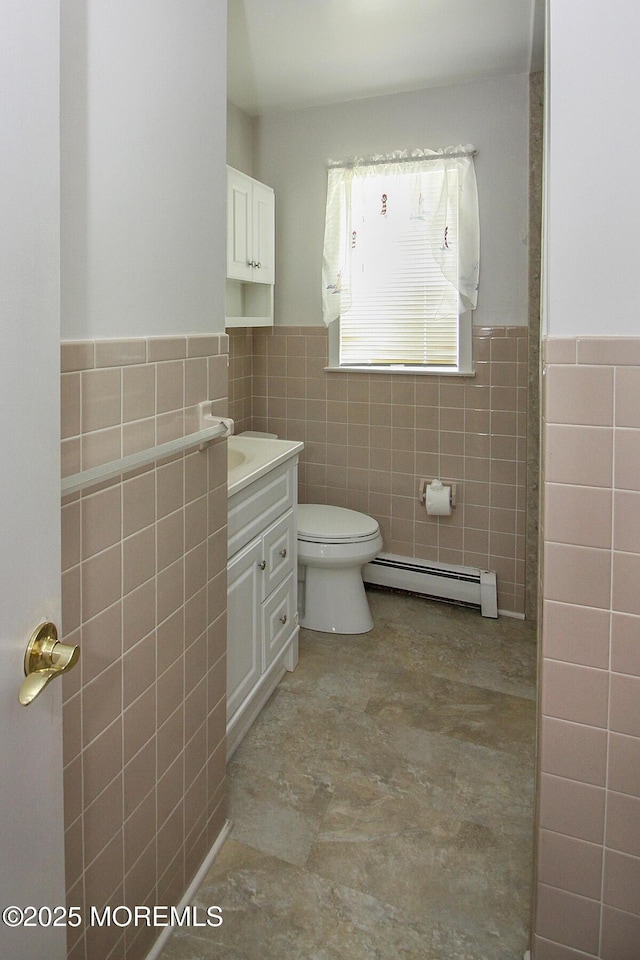 288 Barbados Dr N, Toms River, NJ 08757 - bathroom featuring a baseboard heating unit, tile walls, vanity, and a wainscoted wall