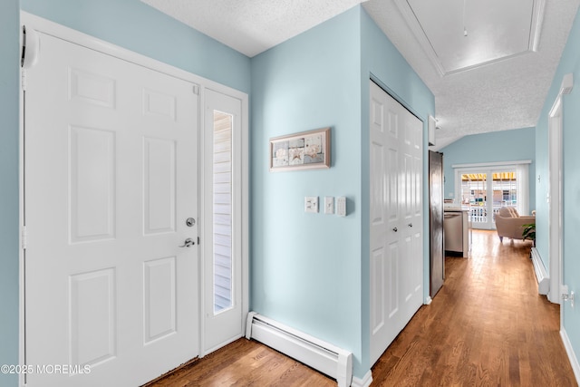 82 Spinnaker Ct, Bayville, NJ 08721 - entrance foyer featuring a baseboard radiator, a textured ceiling, wood finished floors, and lofted ceiling