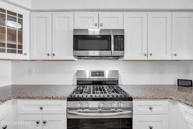 82 Spinnaker Ct, Bayville, NJ 08721 - kitchen featuring appliances with stainless steel finishes, white cabinetry, glass insert cabinets, and tasteful backsplash