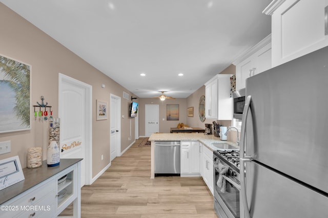 241 Hiering Ave, Seaside Heights, NJ 08751 - kitchen featuring stainless steel appliances, recessed lighting, white cabinetry, light wood finished floors, and a peninsula