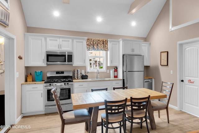 241 Hiering Ave, Seaside Heights, NJ 08751 - kitchen featuring stainless steel appliances, lofted ceiling, light wood-style floors, white cabinetry, and recessed lighting
