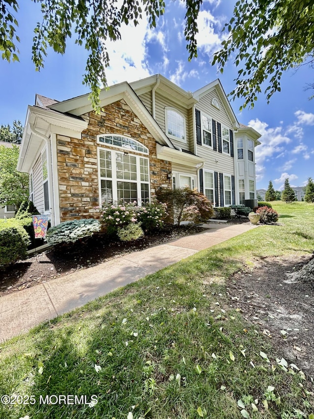 205 Shinnecock Dr, Manalapan, NJ 07726 - view of front of home with stone siding and a front yard