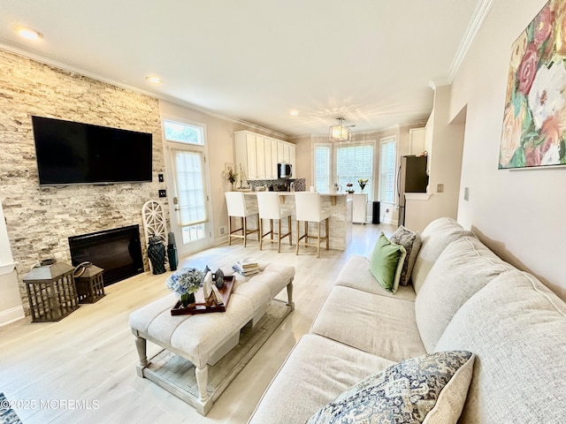 205 Shinnecock Dr, Manalapan, NJ 07726 - living room featuring ornamental molding, light wood-type flooring, a fireplace, and recessed lighting