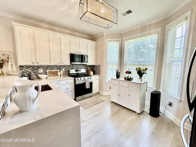 205 Shinnecock Dr, Manalapan, NJ 07726 - kitchen featuring appliances with stainless steel finishes, tasteful backsplash, healthy amount of natural light, and crown molding