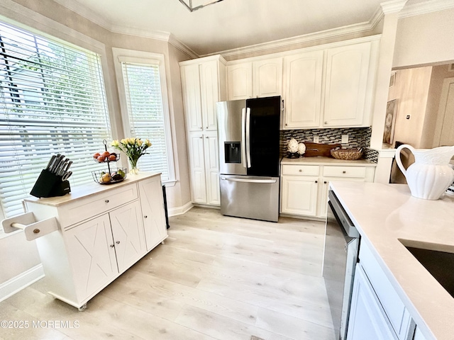 205 Shinnecock Dr, Manalapan, NJ 07726 - kitchen with appliances with stainless steel finishes, ornamental molding, white cabinets, and light countertops