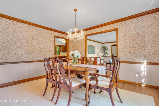 22 Hunt Rd, Freehold, NJ 07728 - dining space with crown molding, wallpapered walls, a chandelier, wainscoting, and wood finished floors