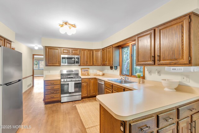 22 Hunt Rd, Freehold, NJ 07728 - kitchen featuring appliances with stainless steel finishes, brown cabinets, and plenty of natural light