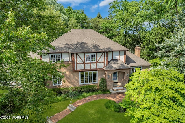 22 Hunt Rd, Freehold, NJ 07728 - view of front of house featuring brick siding, a chimney, roof with shingles, view of scattered trees, and a front yard