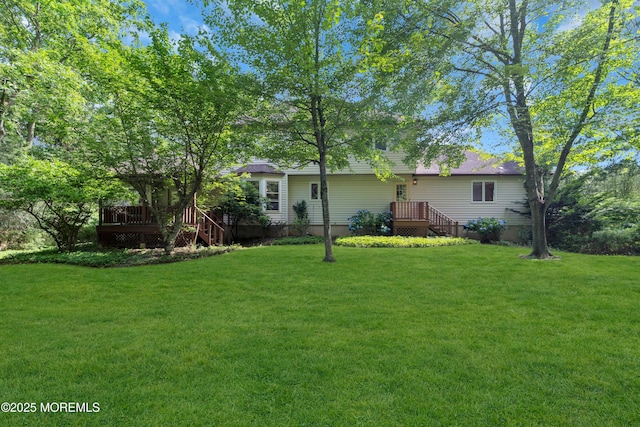 22 Hunt Rd, Freehold, NJ 07728 - rear view of property featuring a lawn and a deck