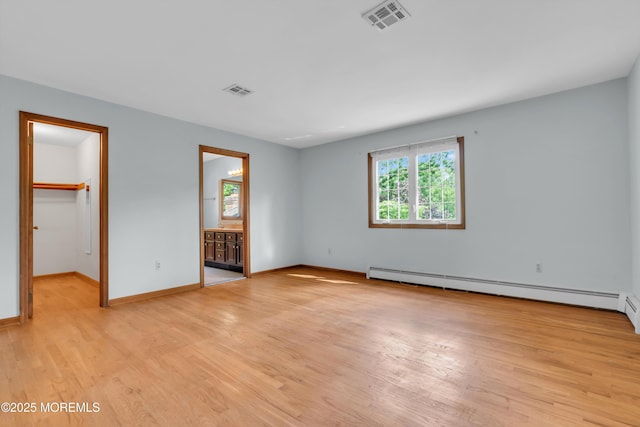22 Hunt Rd, Freehold, NJ 07728 - unfurnished bedroom with light wood-type flooring, a baseboard radiator, a spacious closet, connected bathroom, and a closet