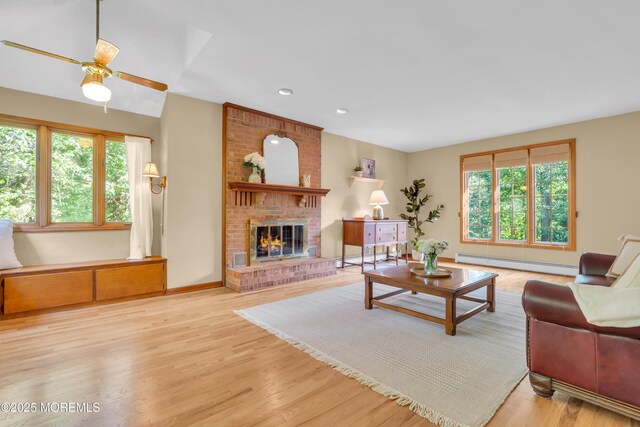 22 Hunt Rd, Freehold, NJ 07728 - living area with a baseboard heating unit, a fireplace, wood finished floors, ceiling fan, and recessed lighting