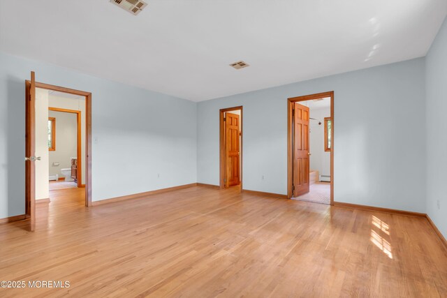 22 Hunt Rd, Freehold, NJ 07728 - unfurnished bedroom featuring light wood-style flooring and baseboard heating