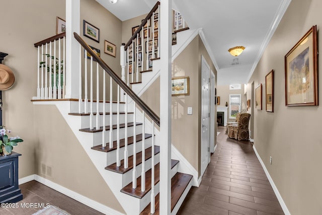 134 Marina Bay Ct, Highlands, NJ 07732 - stairway with a fireplace, wood finished floors, and crown molding