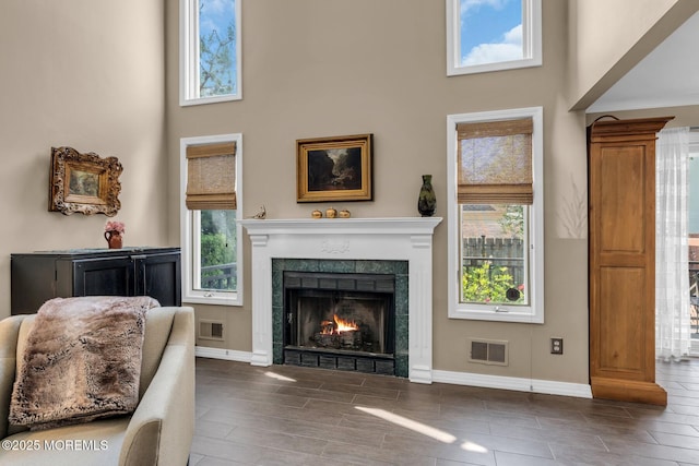 134 Marina Bay Ct, Highlands, NJ 07732 - living area featuring a towering ceiling, a fireplace, and wood finish floors
