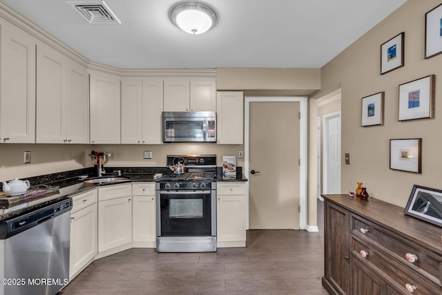 134 Marina Bay Ct, Highlands, NJ 07732 - kitchen featuring stainless steel appliances, dark wood-style flooring, and white cabinets