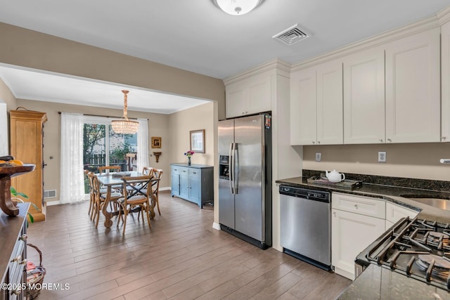 134 Marina Bay Ct, Highlands, NJ 07732 - kitchen with stainless steel appliances, white cabinetry, light wood-type flooring, hanging light fixtures, and dark stone counters