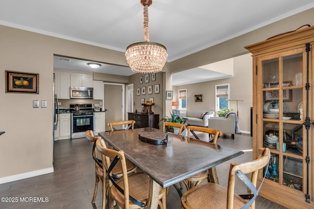 134 Marina Bay Ct, Highlands, NJ 07732 - dining area with a chandelier, ornamental molding, and dark wood-type flooring