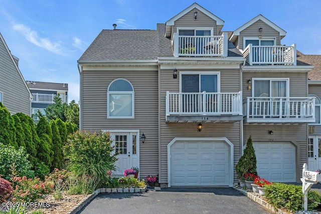 134 Marina Bay Ct, Highlands, NJ 07732 - view of front of property featuring a balcony, an attached garage, driveway, and a shingled roof