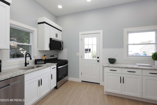 623 Central Ave, Union Beach, NJ 07735 - kitchen with appliances with stainless steel finishes, light wood-style floors, white cabinetry, backsplash, and recessed lighting