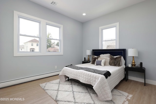 623 Central Ave, Union Beach, NJ 07735 - bedroom featuring a baseboard heating unit, light wood-style floors, and recessed lighting