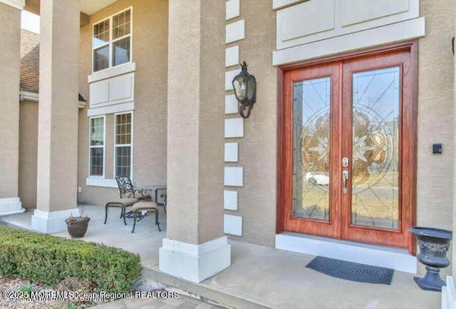 6 Meadow Run Ct, Jackson, NJ 08527 - view of exterior entry with french doors, covered porch, and stucco siding