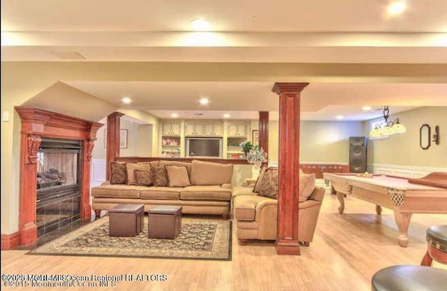 6 Meadow Run Ct, Jackson, NJ 08527 - living area with decorative columns, wood finished floors, wainscoting, a fireplace, and recessed lighting