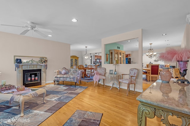 2 Apache Dr, Toms River, NJ 08753 - living area featuring ceiling fan, light wood-style flooring, a glass covered fireplace, a chandelier, and recessed lighting