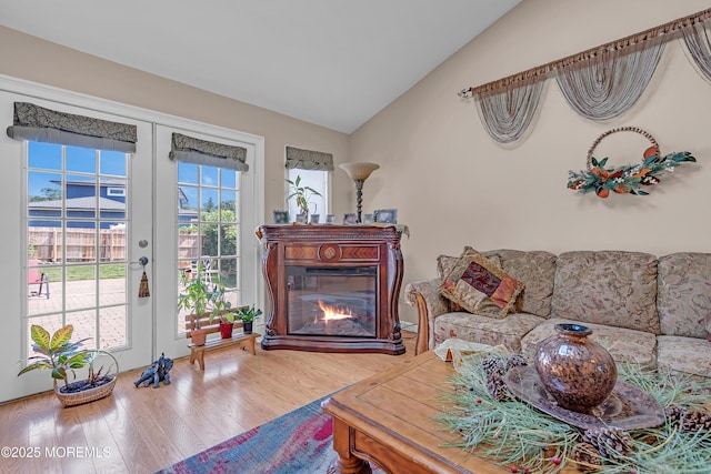 2 Apache Dr, Toms River, NJ 08753 - living room featuring vaulted ceiling, wood finished floors, a glass covered fireplace, and french doors