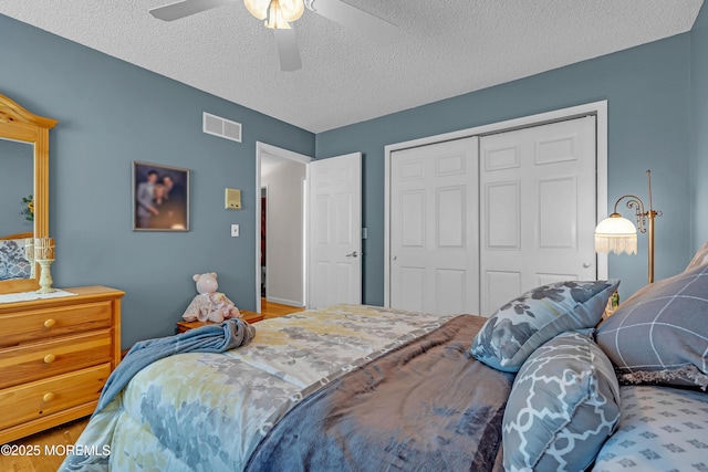 2 Apache Dr, Toms River, NJ 08753 - bedroom with a closet, a textured ceiling, a ceiling fan, and wood finished floors