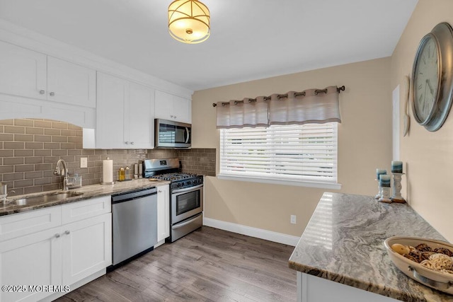 26 Kathy Ct, Brick, NJ 08724 - kitchen with stainless steel appliances, light stone countertops, and white cabinetry