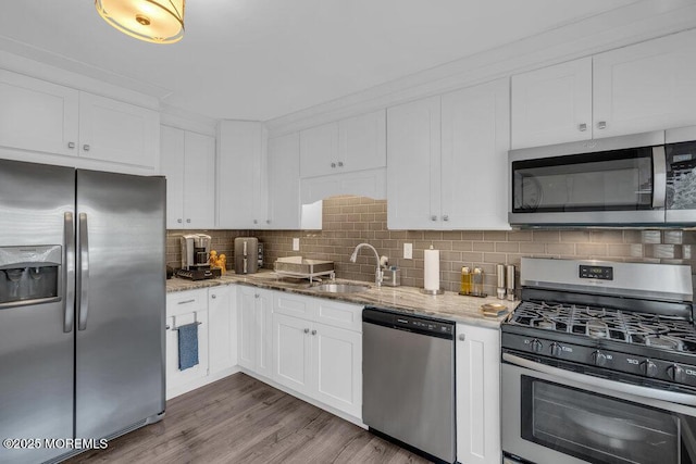 26 Kathy Ct, Brick, NJ 08724 - kitchen featuring stainless steel appliances, white cabinets, decorative backsplash, and light stone counters