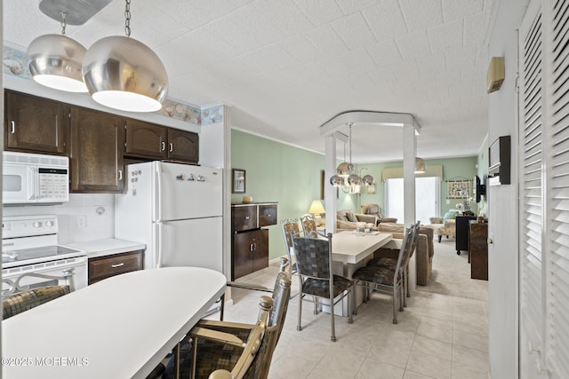 51 Hiering Ave Unit C 12, Seaside Heights, NJ 08751 - kitchen featuring white appliances, dark brown cabinets, light tile patterned floors, open floor plan, and decorative light fixtures