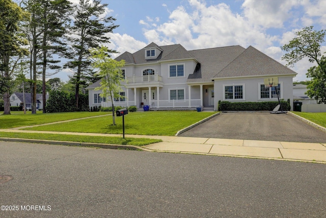 1 Country Club Dr, Deal, NJ 07723 - view of front of home with a front yard, stucco siding, a balcony, and driveway