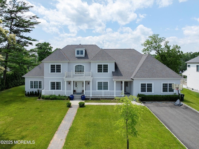 1 Country Club Dr, Deal, NJ 07723 - view of front of house featuring covered porch, a balcony, stucco siding, and a front yard