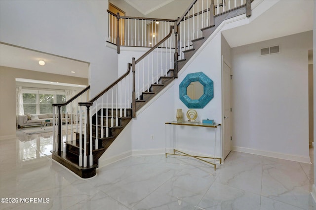 1 Country Club Dr, Deal, NJ 07723 - staircase featuring marble finish floors, a high ceiling, and crown molding