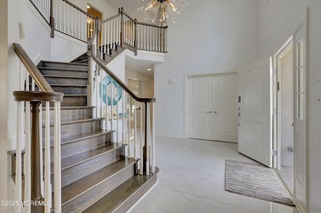 1 Country Club Dr, Deal, NJ 07723 - entrance foyer featuring a towering ceiling, a chandelier, marble finish floors, and stairway