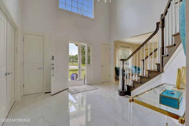 1 Country Club Dr, Deal, NJ 07723 - foyer featuring marble tiled flooring, a towering ceiling, and stairs