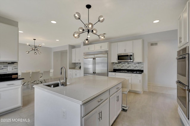 1 Country Club Dr, Deal, NJ 07723 - kitchen featuring appliances with stainless steel finishes, a chandelier, tasteful backsplash, white cabinetry, and recessed lighting