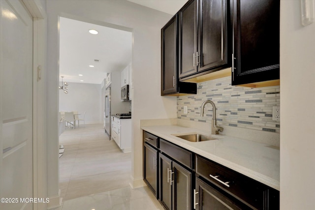 1 Country Club Dr, Deal, NJ 07723 - kitchen with decorative backsplash, stainless steel microwave, light countertops, fridge, and a chandelier