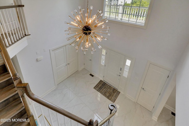 1 Country Club Dr, Deal, NJ 07723 - entrance foyer featuring marble finish floors, a towering ceiling, a chandelier, and stairway