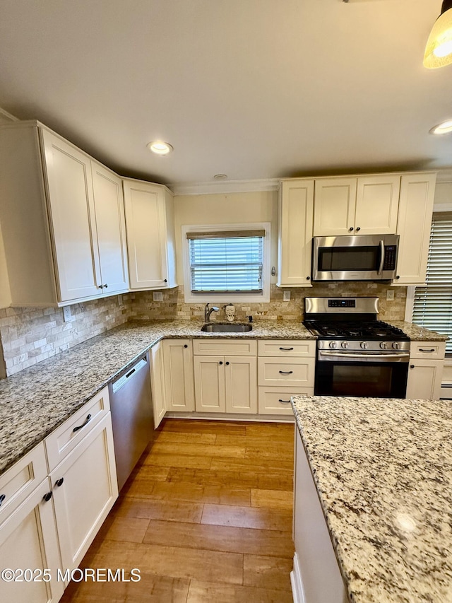 3 Tivoli St, Toms River, NJ 08757 - kitchen featuring appliances with stainless steel finishes, white cabinetry, decorative backsplash, ornamental molding, and recessed lighting