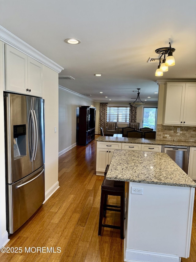3 Tivoli St, Toms River, NJ 08757 - kitchen featuring stainless steel appliances, a peninsula, ornamental molding, wood finished floors, and recessed lighting